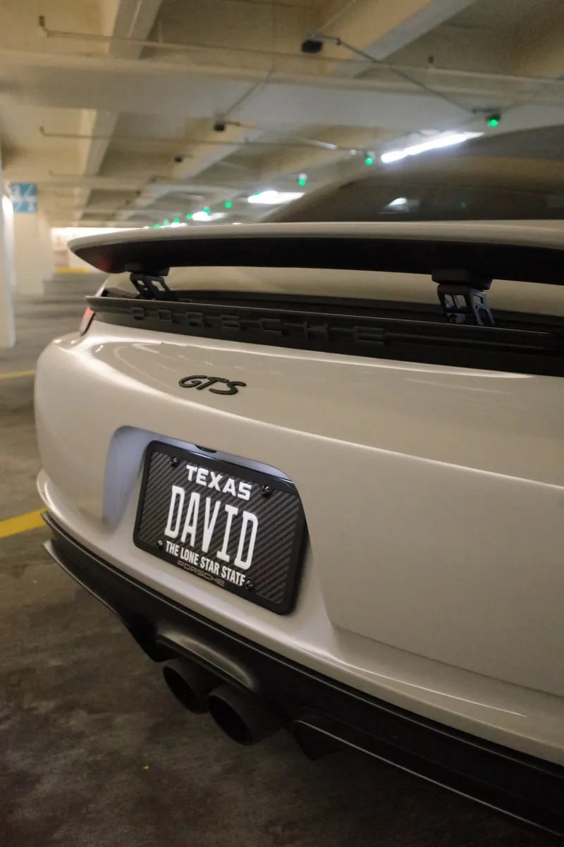 White Porsche 718 Cayman GTS with a Texas plate reading DAVID